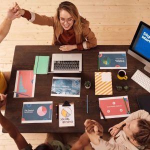 Colleagues celebrating success in a modern digital marketing office with teamwork and collaboration.